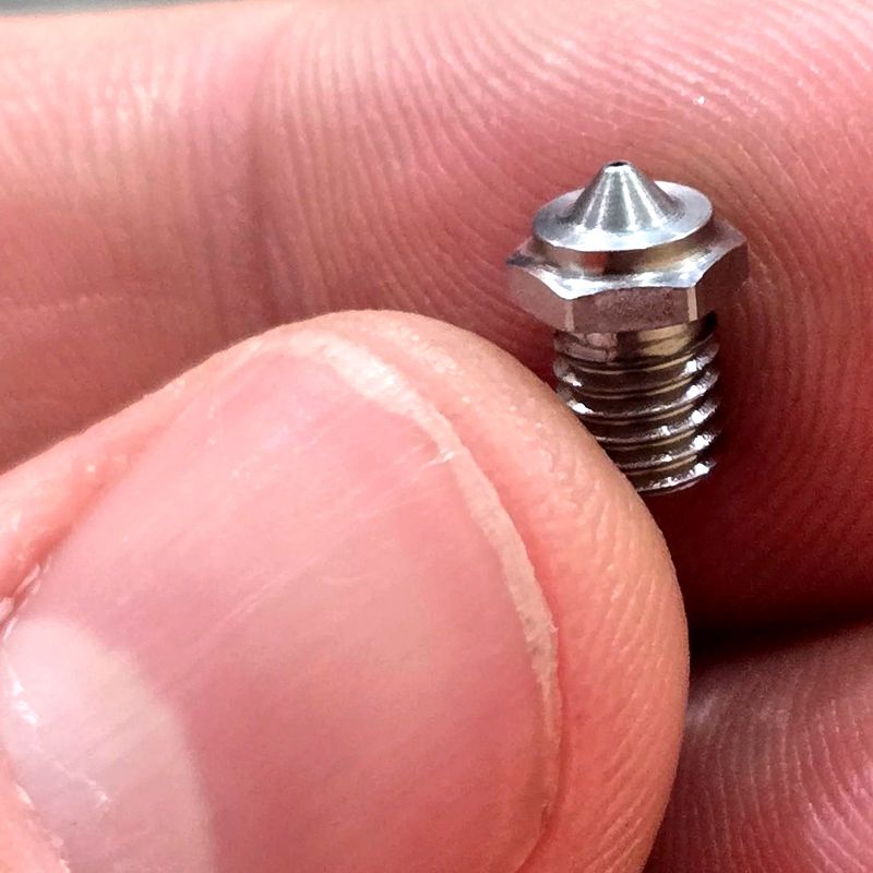 Small nozzle held between fingers